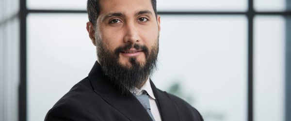 young businessman in the office with his arms crossed