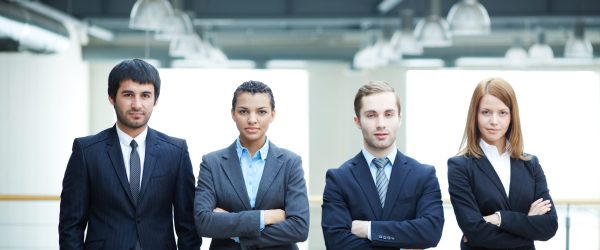 Group of friendly businesspeople in suits standing in line